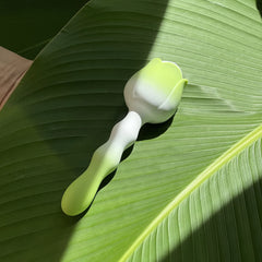 Soft lighting and elegant form of the Blossom Intimacy Massager representing feminine calm and sensual confidence